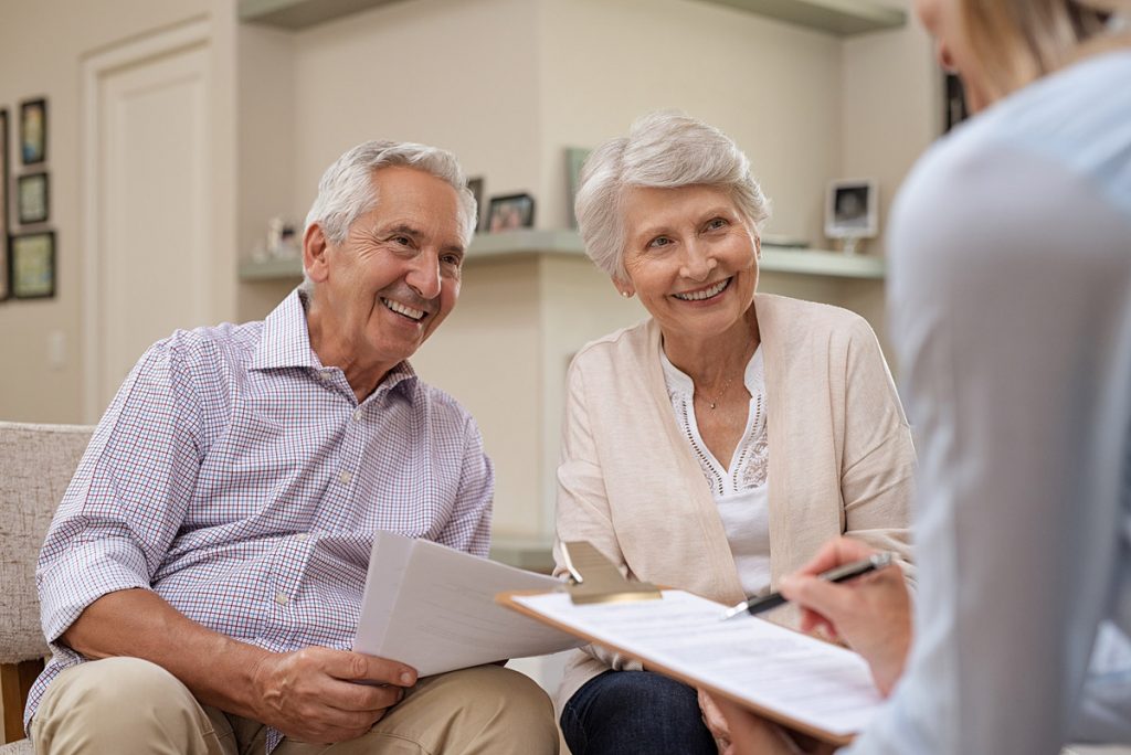 An elderly couple discussing estate planning with local lawyers