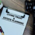 Image of a clipboard with a piece of paper reading "Living Trust & Estate Planning"