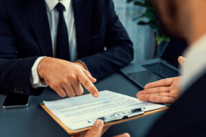 Image of two people working together and consulting over a legal document