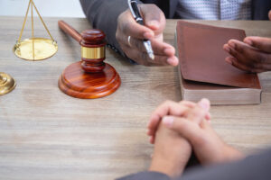 Image of a probate attorney consulting with a client at a desk with a gavel and notebook