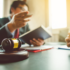 Image of an attorney working with a client at a desk with a gavel in the foreground