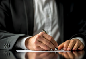 Image of an attorney writing on a piece of paper