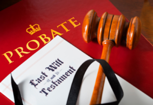 Image of a gavel on top of a last will and testament and a document labeled Probate