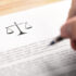 Image of an attorney writing on a document